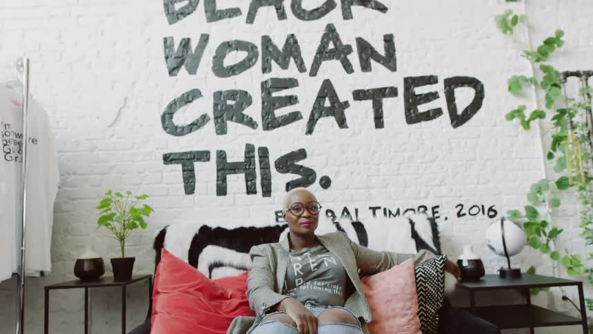 Woman is sitting on a couch
