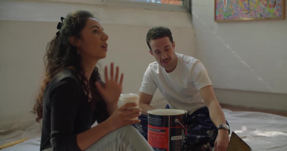 Young woman and man are sitting down talking