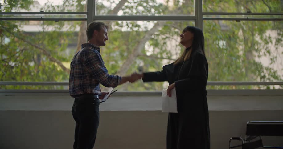 Man and woman shake each others hand