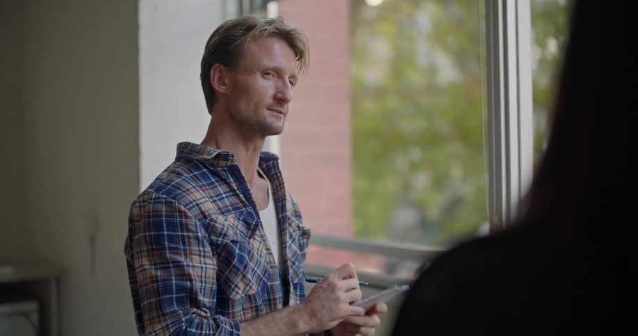 Young man is talking to a woman