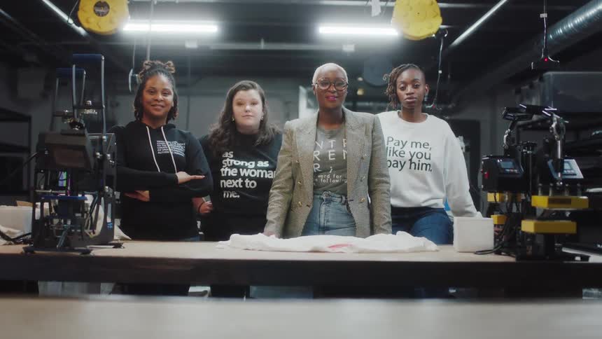 Four woman are in a warehouse working together