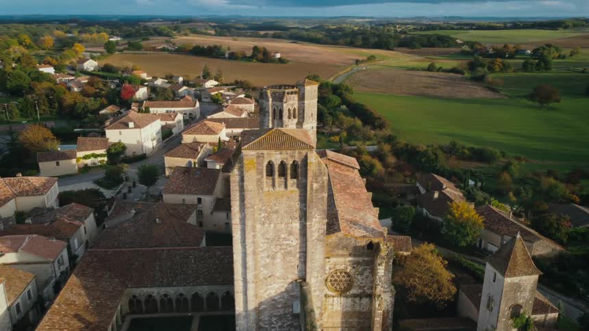 A large building in a small town in the countryside during the day