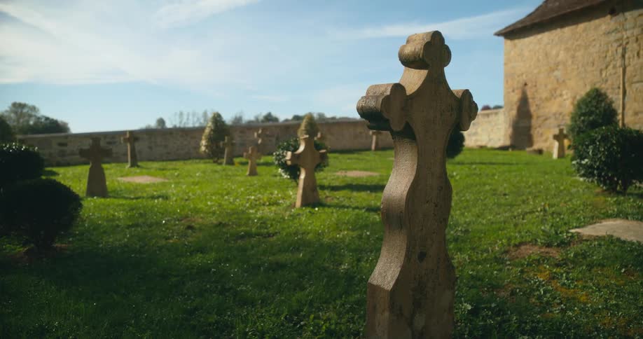 A graveyard of a church has crosses for markers