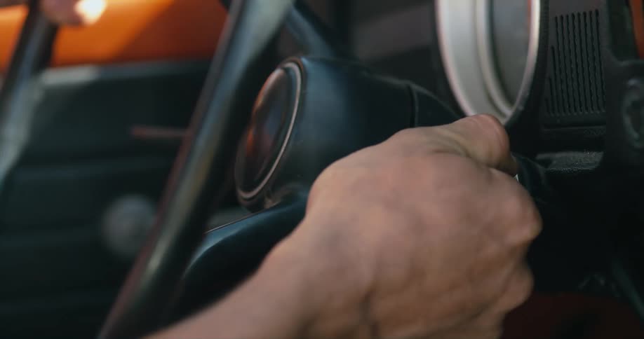 A man is starting his vehicle with a key
