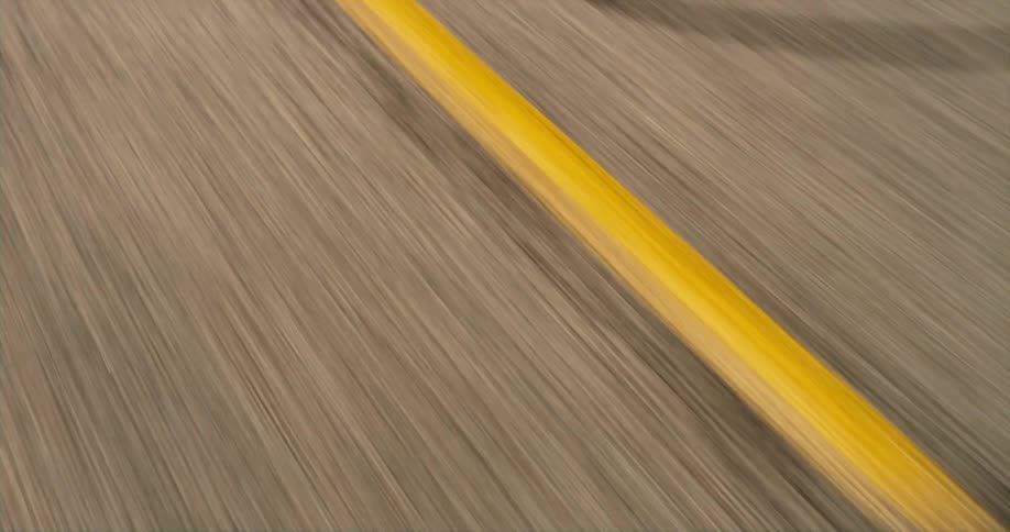 Moving on a road with yellow passing lines on the pavement