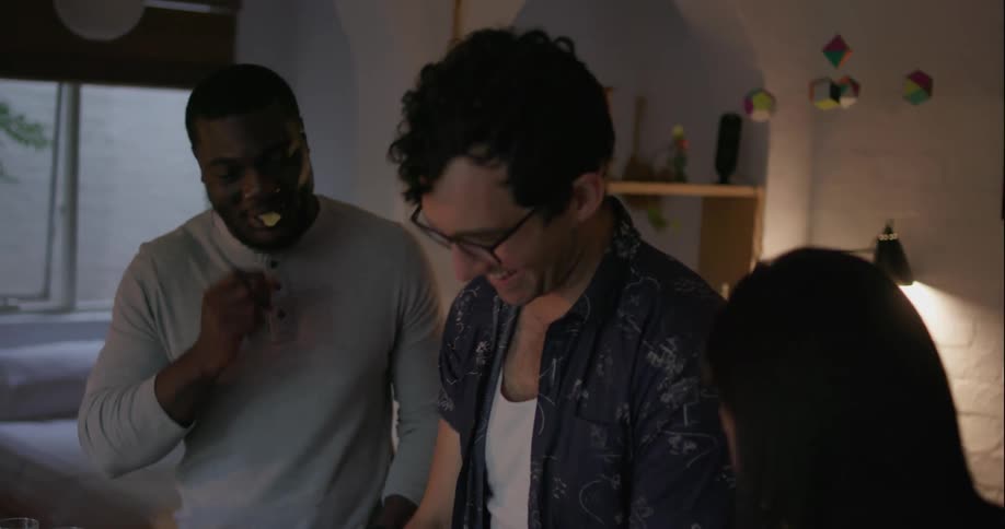A group of people are getting food at a table