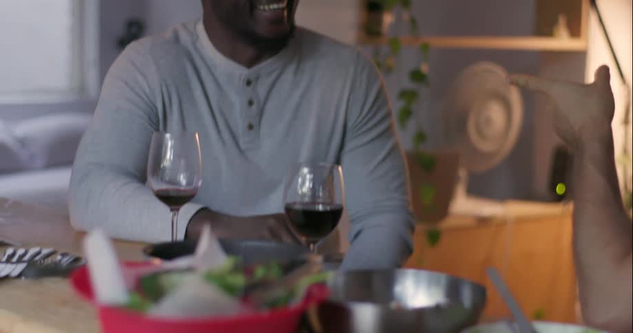 Two men chat while drinking red wine