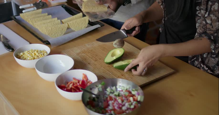 Man and woman make tacos together