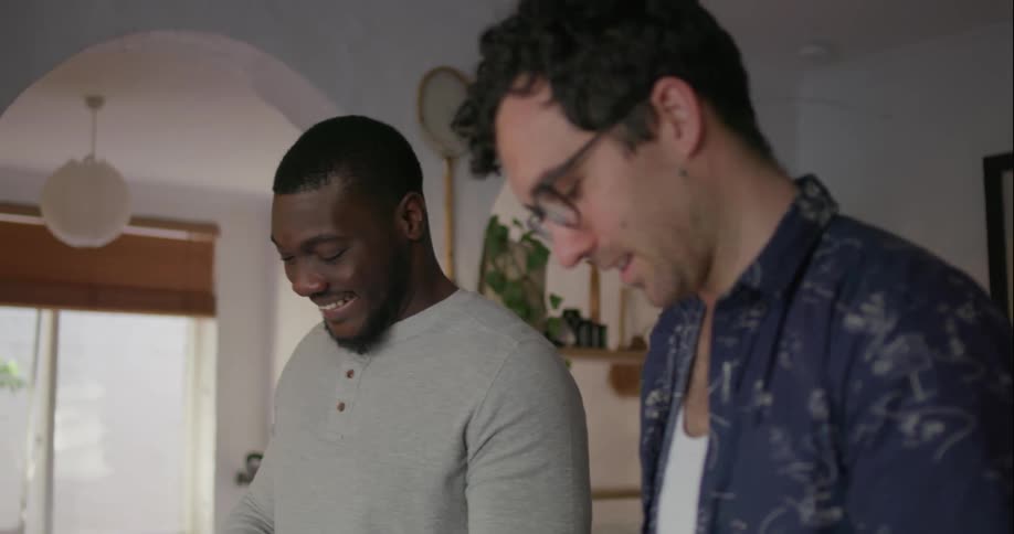 Two men talk while they cut up food