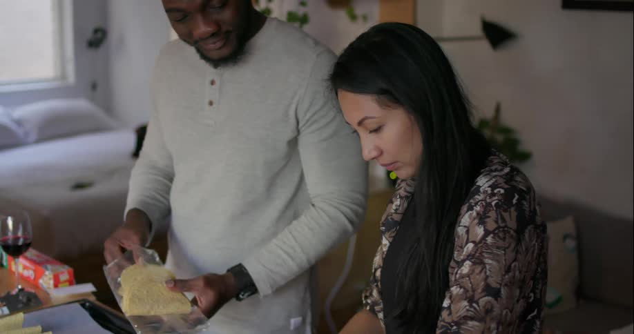 A couple are preparing tacos in the kitchen