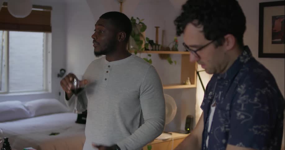 Two men talk and cook food