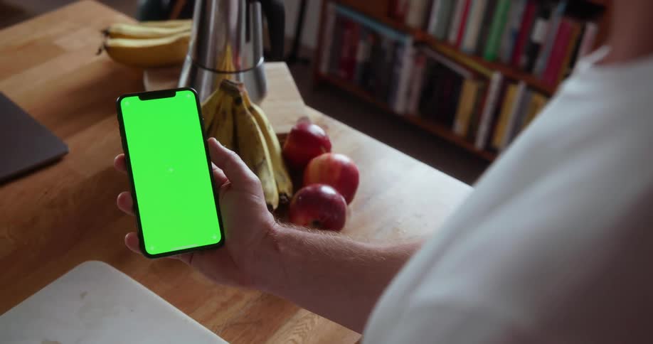 A person is using their phone at home