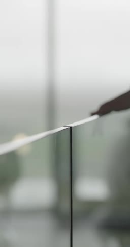 A womans hand rubbing a glass table