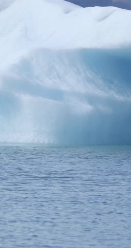 Water rippling in front of snow in the arctic