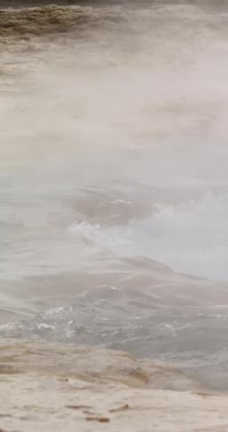 Steam floating above flowing water in nature