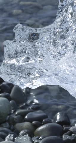 Ice and smooth pebbles on a lakeshore