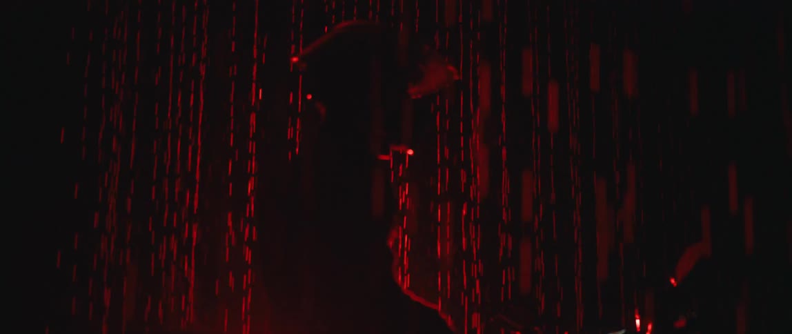 A man sits on a motorcycle in front of simulated led rain lights