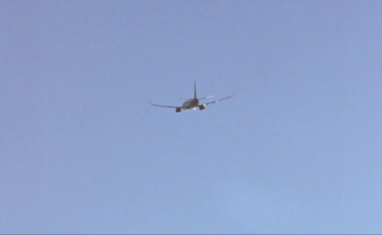 An airplane travels through the sky on a clear day
