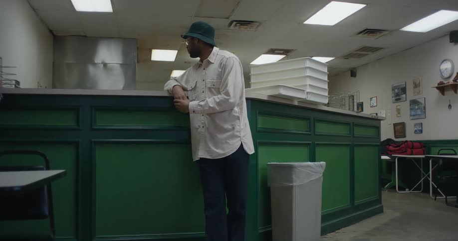 Man waits at counter in restaurant