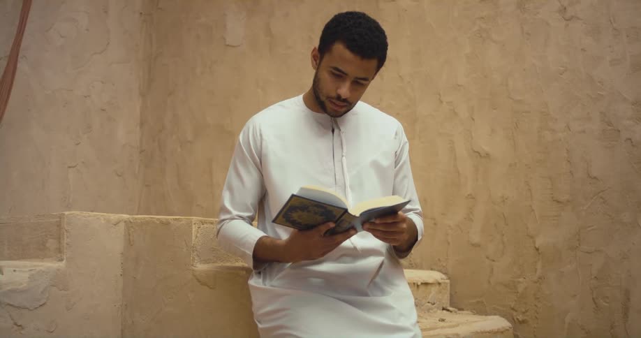 A man standing around reading a book