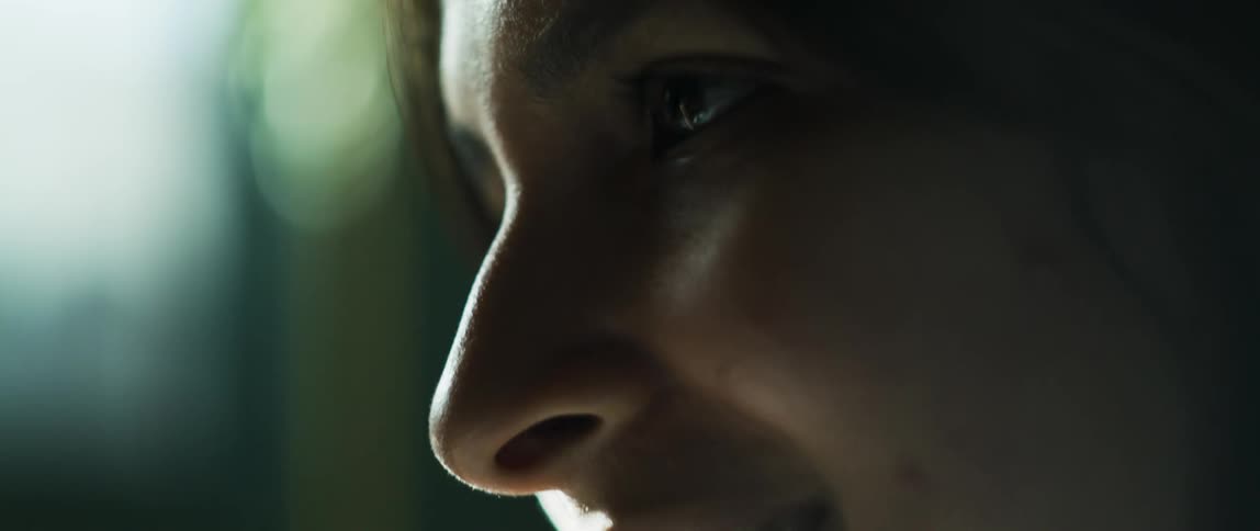 Side profile of woman talking to person and sun shining on her face