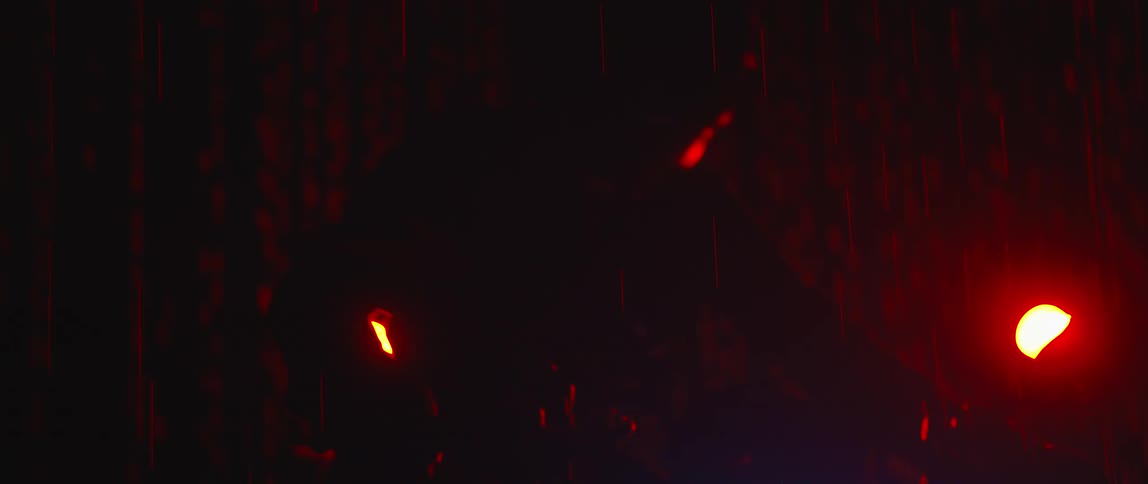 A view of a car headlight in the rain