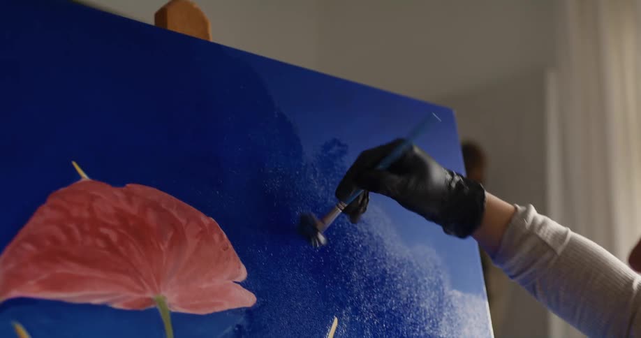 A woman painting on a canvas