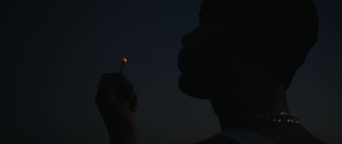 A person smoking a cigarette outdoors