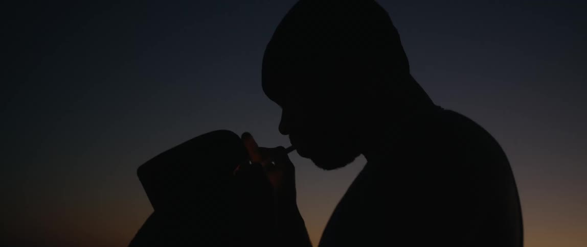 A man lighting a cigarette