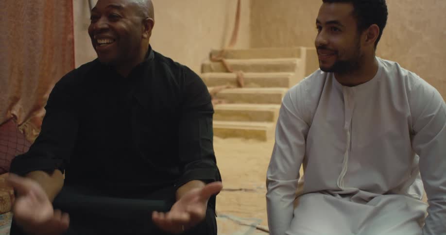 Two men sitting outdoors talking