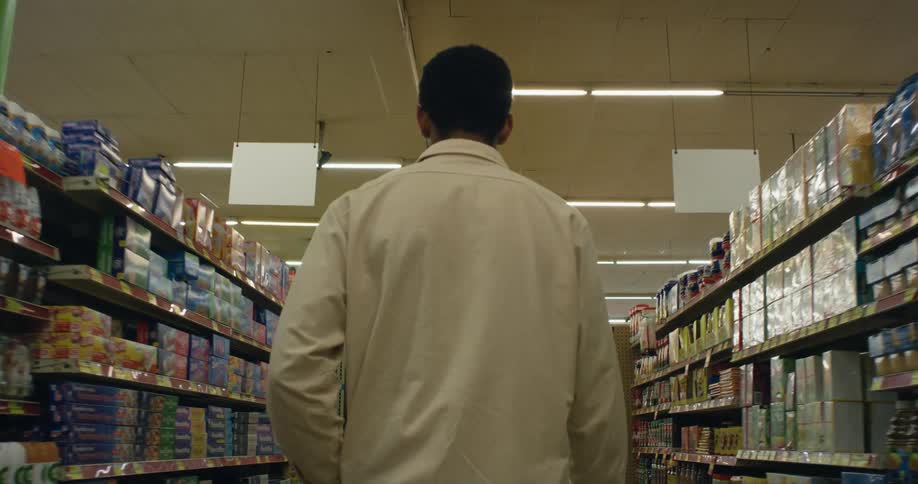 Man walks down aisle in grocery store