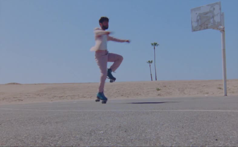 A man is skating outdoors on a rural street