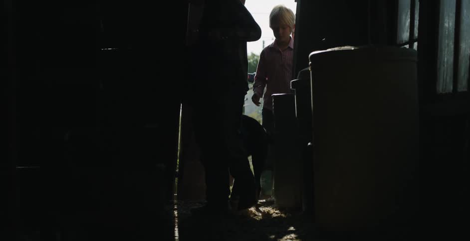 People and a dog enter the barn