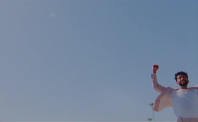 A man is dancing and spinning around outdoors