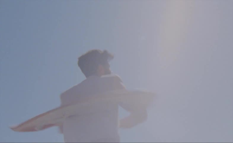 A man is dancing outdoors during the day time