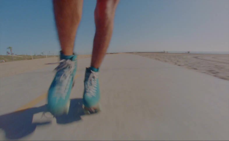 A man is roller skating on the boardwalk