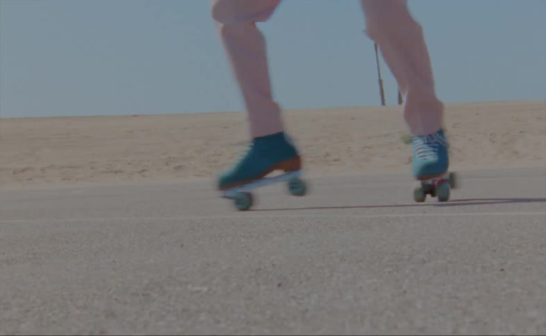 A person dances in roller skates outdoors during the day