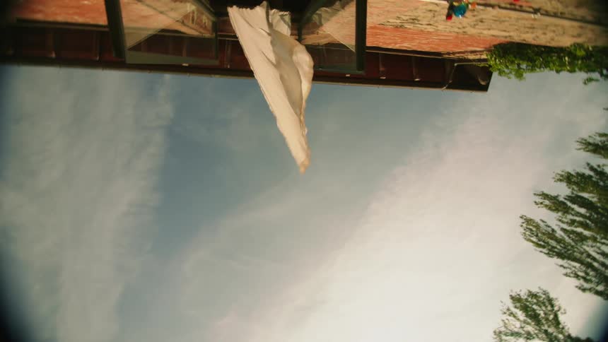 Drapes out of a window in a home