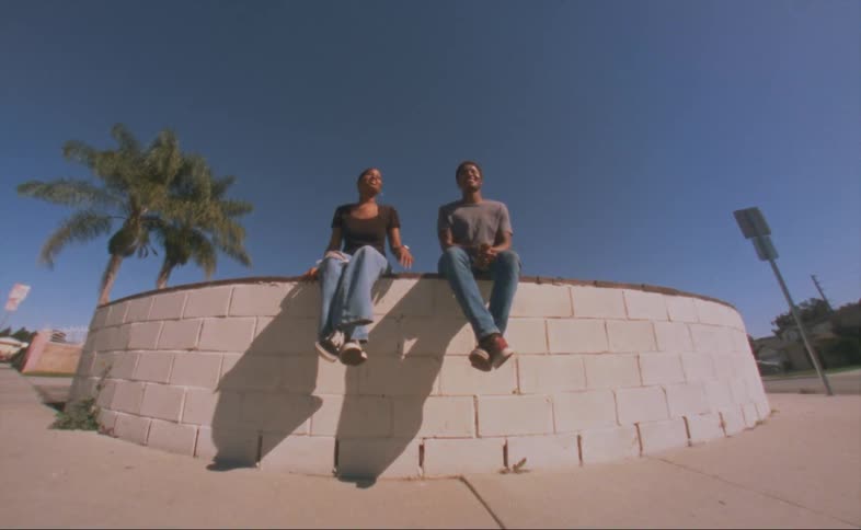 Two friends sitting outdoors talking