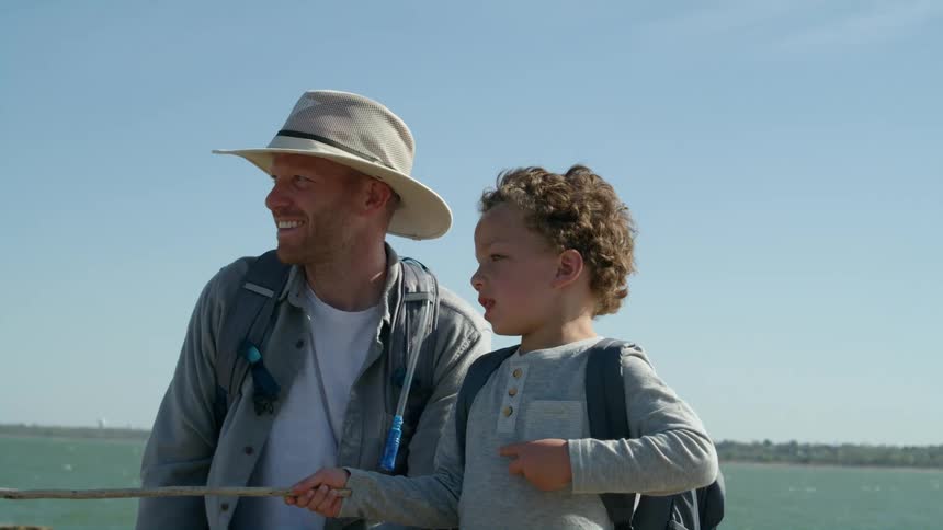 A child is pointing something out with a stick