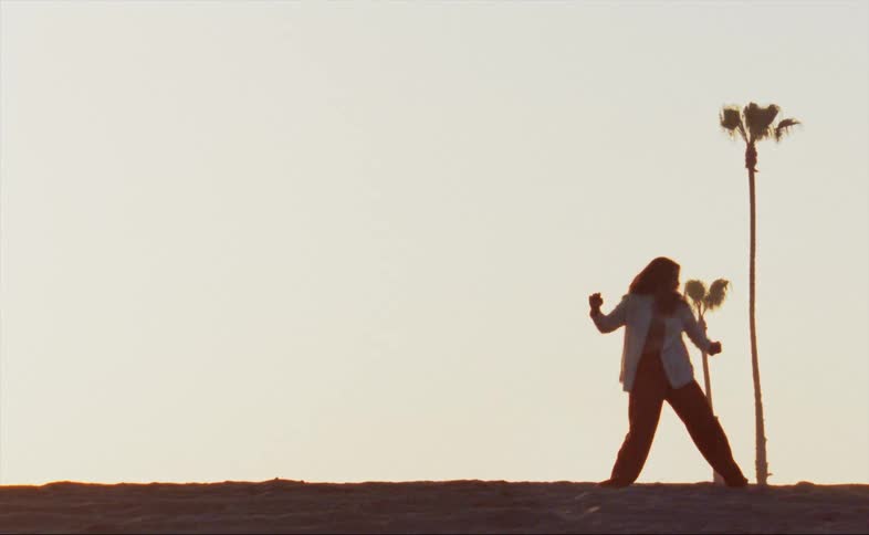 A woman kicks around dancing
