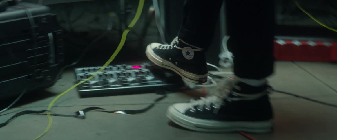 A musician walks back and forth and steps on a sound mixer on the ground