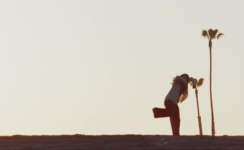 A woman is dancing outside