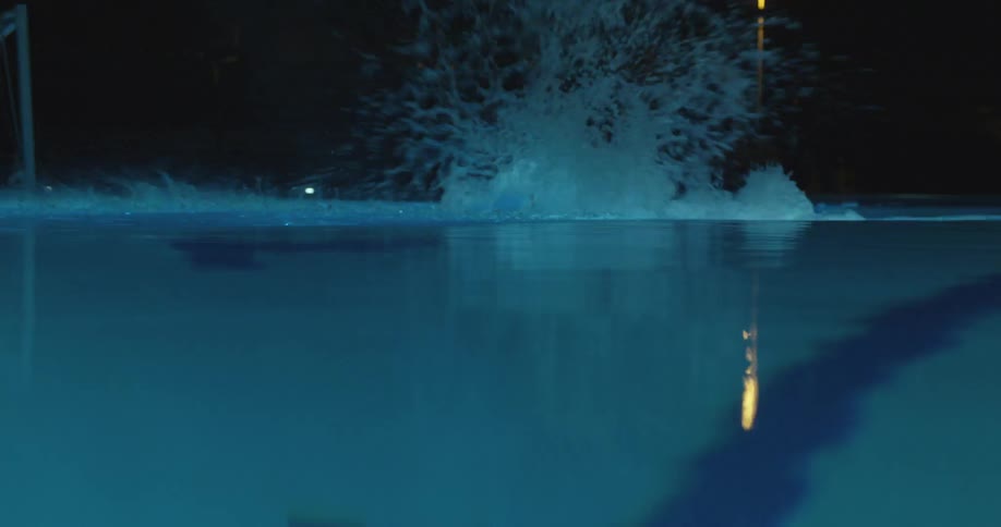Someone dives into a pool