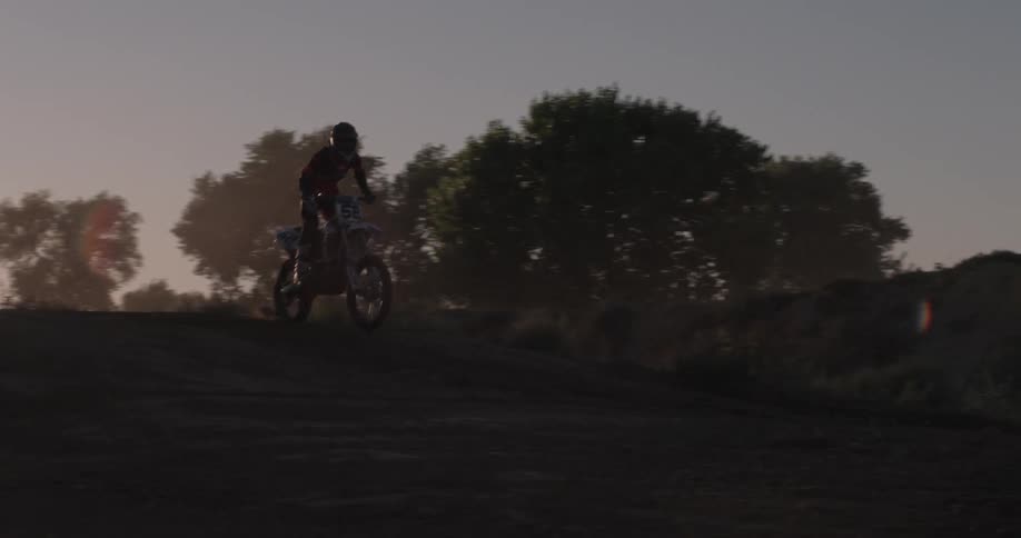 A person rides a bike on a dirt track