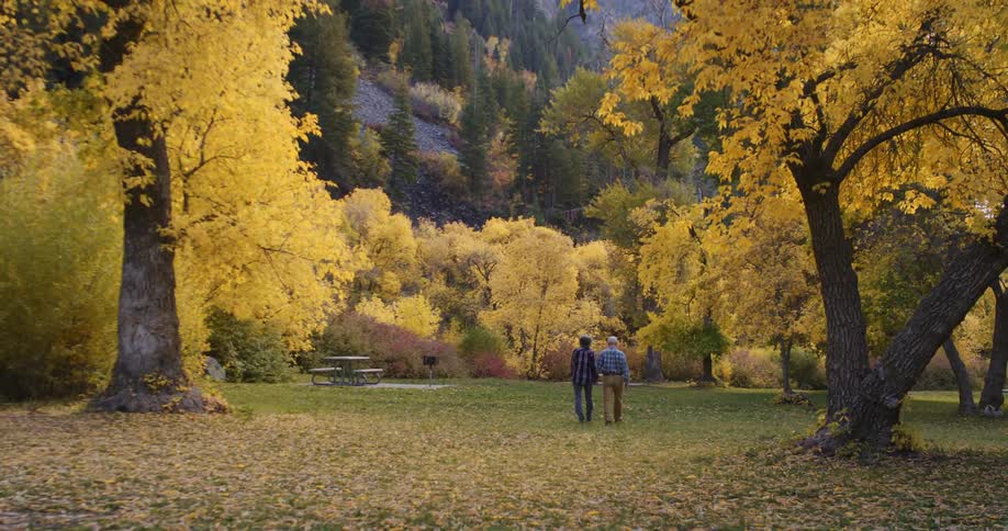 A couple walk towards the mountain