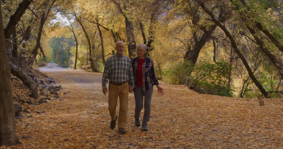 A man and woman hike through the forest