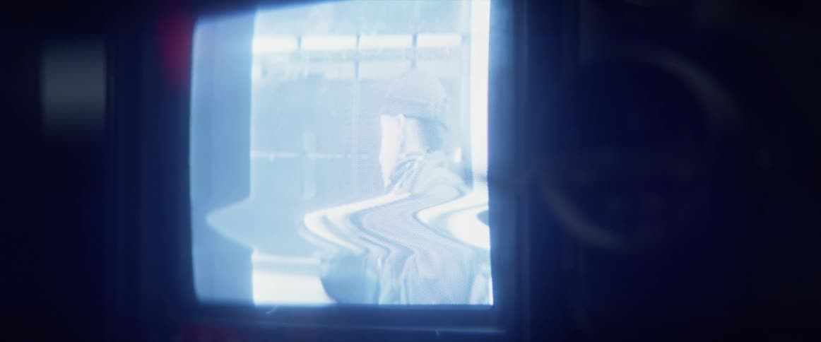 A man is on a tv show on a distorted screen