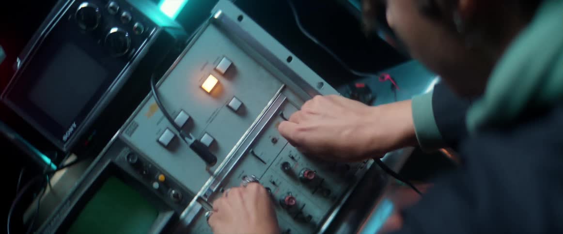 A man twisting knobs on an electronic device