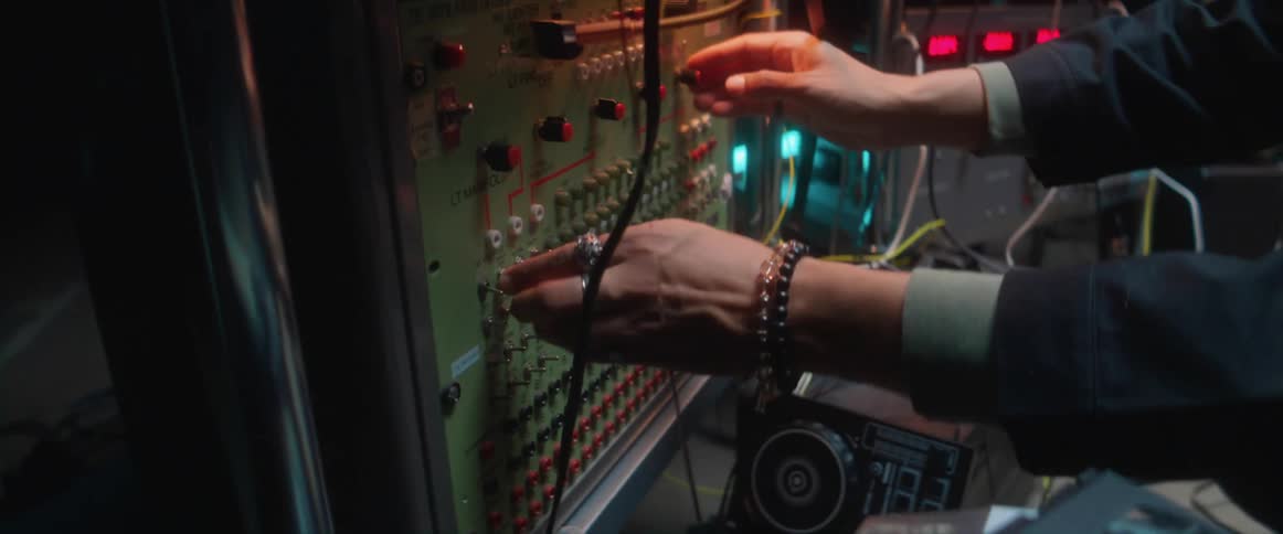 Young man using electronic equipment inside a dimly lit room